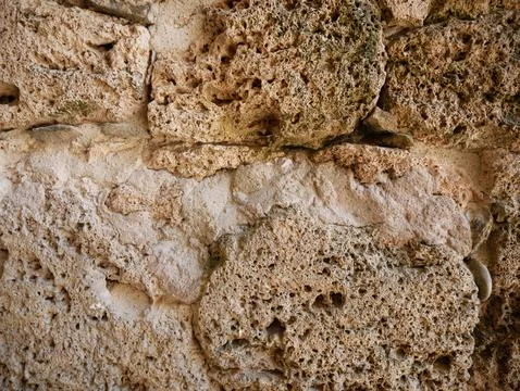 Detailed rough stone wall texture background with natural earthy colors, weather Stock Photos