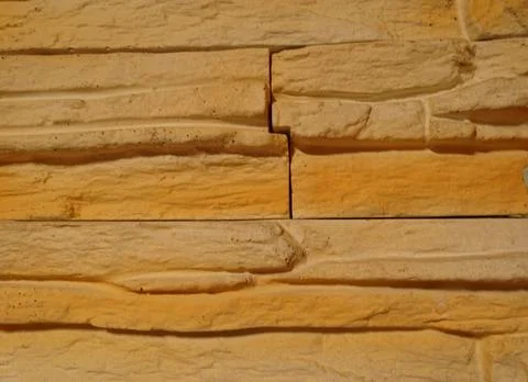 Detailed rustic stone wall texture background with yellow bricks Stock Photos