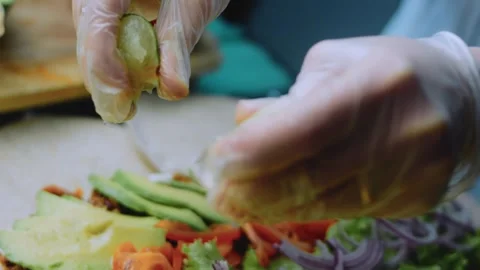 Detailed serving view: securing a loaded burrito for serving Stock Footage 342167988