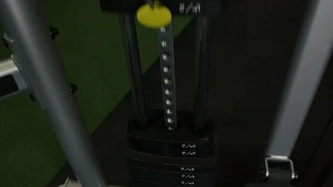 Detailed shot of cable machine weight stack lifting up at the gym 库存影片 95085833
