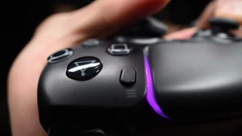 Detailed shot of gaming controller with LED light and players hands 動画素材 319141088