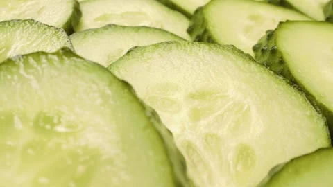 A detailed sliding close-up captures the freshness of crisp cucumber slices. Stock Footage 313832877
