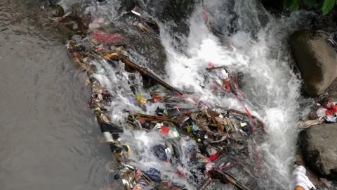 Detailed slow motion of plastic garbage clogging river stream. Stock Footage 336322787