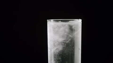 Detailed slow-motion view of ice cubes moving and melting in a glass of water 스톡 동영상 342735932