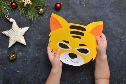 Detailed step-by-step instructions for making tiger masks from paper for chil Stock Photos