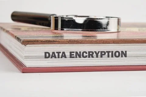 A detailed study guide on data encryption is placed on a surface alongside a  写真素材