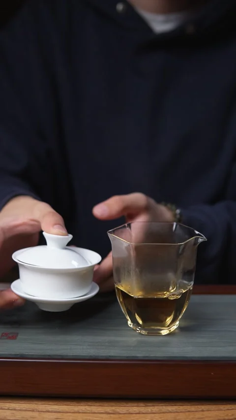 The Detailed Tea Brewing Process Using a Gaiwan and a Glass Cup for Enjoyment Video stock 301890913