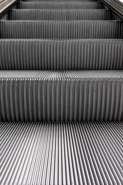 Detailed texture of grooved escalator steps. Abstract metal pattern for ind.. Stock Photos