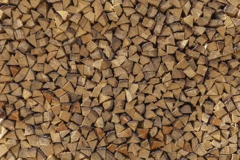 Detailed texture of a large wall of split firewood logs Stock Photos