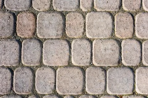 Detailed texture of paved pathway built with small blocks. Stock Photos