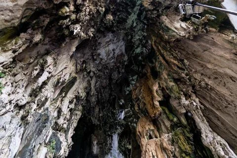 Detailed texture of rugged limestone cave walls and ceiling at Batu Caves Stock Photos