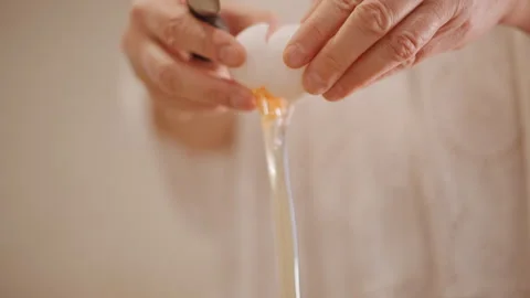 Detailed tutorial on gently opening eggs without breaking shells. Instructional Stock Footage 348301011