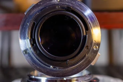 A detailed view of the back side of an old camera lens with mount and apertur Fotos Stock