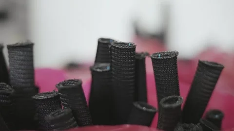 Detailed view of black coiled cable insulation organized in production proces Stock Footage 331891665