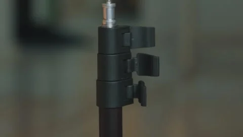Detailed View of a Black Studio Light Stand's Height Adjustment Locking Clips Stock Footage 333317662