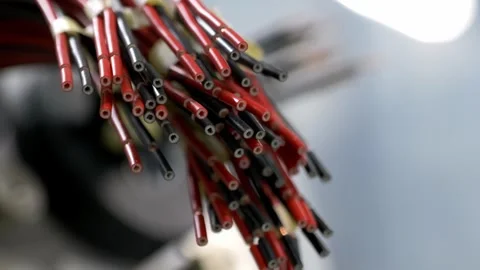 Detailed view of a bundle of red and black electrical wires in a factory Stock Footage 328644935