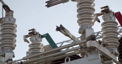Detailed view of ceramic insulators and electrical connections in substation 스톡 동영상 328886492