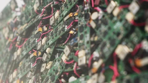 A detailed view of circuit boards featuring green PCBs, red wires, and Video stock 300386599