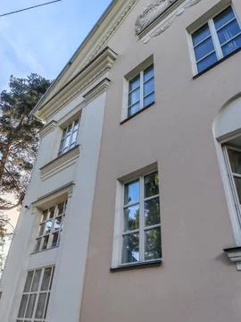 A detailed view of a classical building with clean lines, symmetrical windows Stock Photos