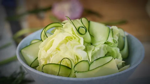 Detailed view of cook meticulously preparing fresh vegetable decorations Stock Footage 324575415