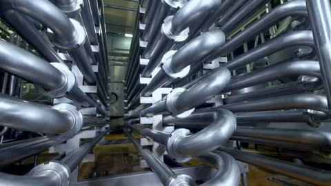 Detailed view on curved steel pipes for pasteurization process. Stock Footage
