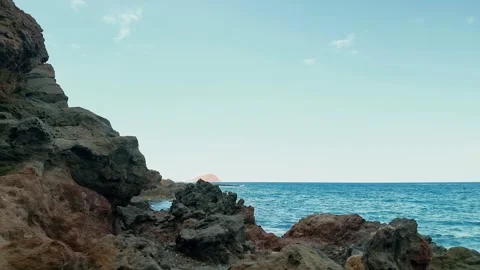 Detailed view of dark volcanic basalt rocks on a rugged beach in the Canary Stock Footage 346480395