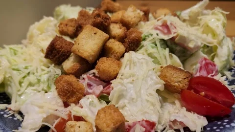 A detailed view of a delicious Caesar salad featuring golden-brown toasted Stock Footage 333222865