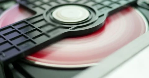 A detailed view of a disc being loaded into a CD player highlighting technology Stock Footage 308232275