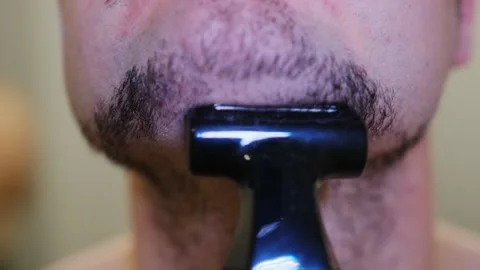 A detailed view of an electric razor efficiently shaving off facial hair Stock-Footage 309502866