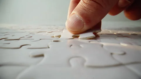 Detailed view finished puzzle on blank table. Mind jigsaw with connected pieces Stock Footage 332310281