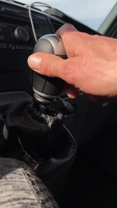 Detailed view of gear shift with charging cable and dashboard Vidéo 347334471