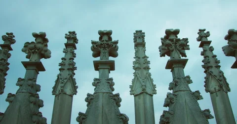 Detailed view of gothic spire finials against blue sky from cathedral rooftop Stock Footage 320090122