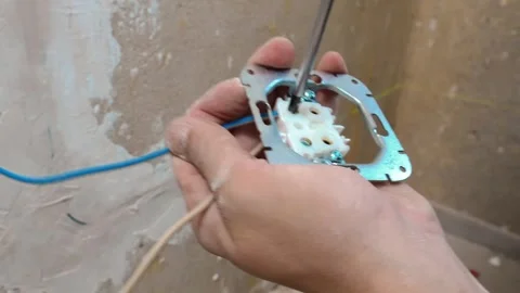 Detailed View Of Hands Adjusting Terminal Wires Before Installation Into Wall Stock Footage 328521272