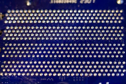 Detailed view of hardware technology surface featuring metallic dots on dark Stock Photos