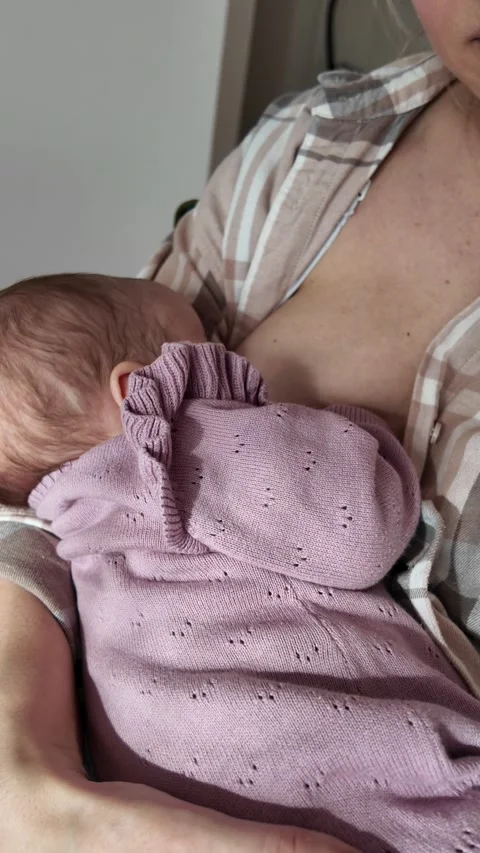 Detailed view of infant nursing correctly. Emphasis on breastfeeding technique Stock Footage 330134127