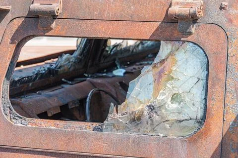 A detailed view of the interior of a war-torn car, with rust and decay taking Stock Photos