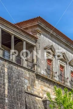 Detailed view at the lateral facade of the Cathedral of Viseu, column gallery Stock Photos