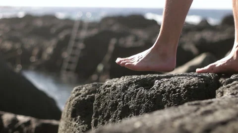 Detailed view of man walking towards the creek Stock Footage 59337137