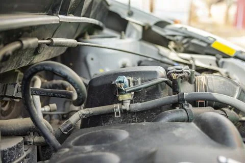 Detailed view of a modern car engine with exposed elements under the hood. .. Stock Photos
