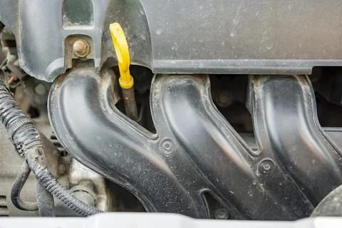 Detailed view of a modern car engine with exposed elements under the hood. .. Stock Photos