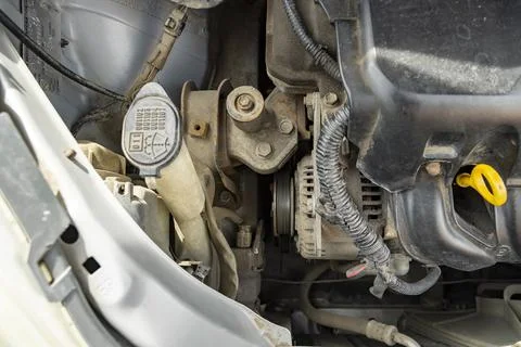 Detailed view of a modern car engine with exposed elements under the hood. .. Stock Photos
