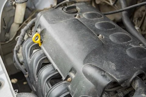 Detailed view of a modern car engine with exposed elements under the hood. .. Stock Photos