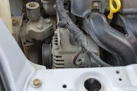 Detailed view of a modern car engine with exposed elements under the hood. .. Stock Photos