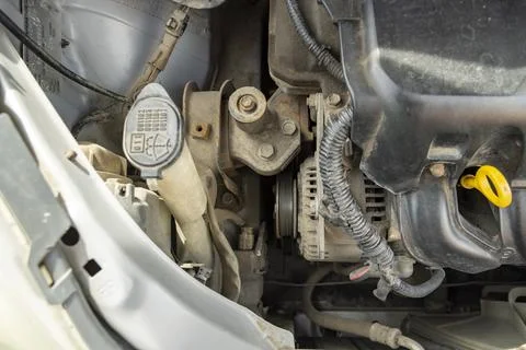 Detailed view of a modern car engine with exposed elements under the hood. .. Stock Photos