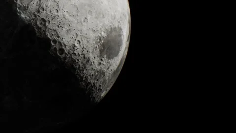 Detailed view of the moon with craters and shadows under a dark sky Stock Footage 344852970