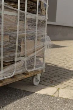 Detailed view of movable caster wheel on cardboard pallet during inspection Photos