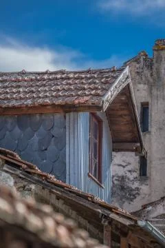 Detailed view of old and rustic house, with roof cock loft on roof Stock Photos