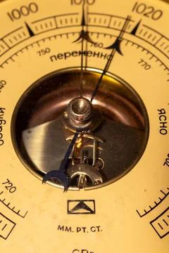 Detailed view of an old barometer dial indicating atmospheric changes with Stockfoto's