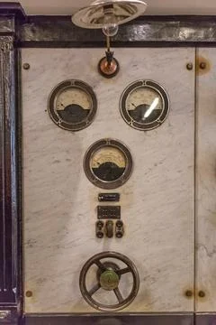 Detailed view of a old control panel with thermostat and pulley Stock Photos