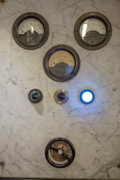 Detailed view of a old control panel with thermostat and pulley Stock Photos